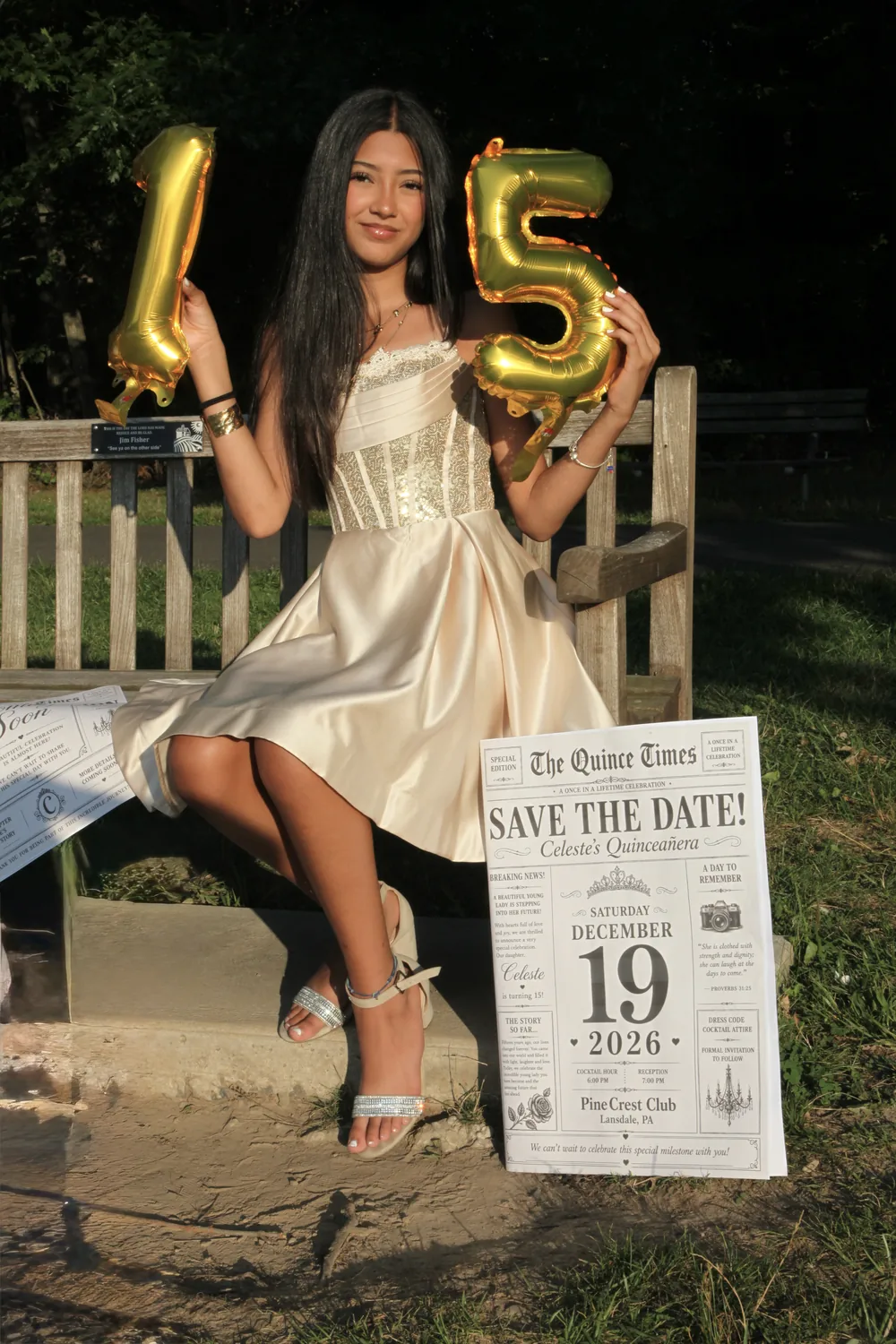 Celeste on a wooden bench, holding gold balloons shaped like 1 and 5.